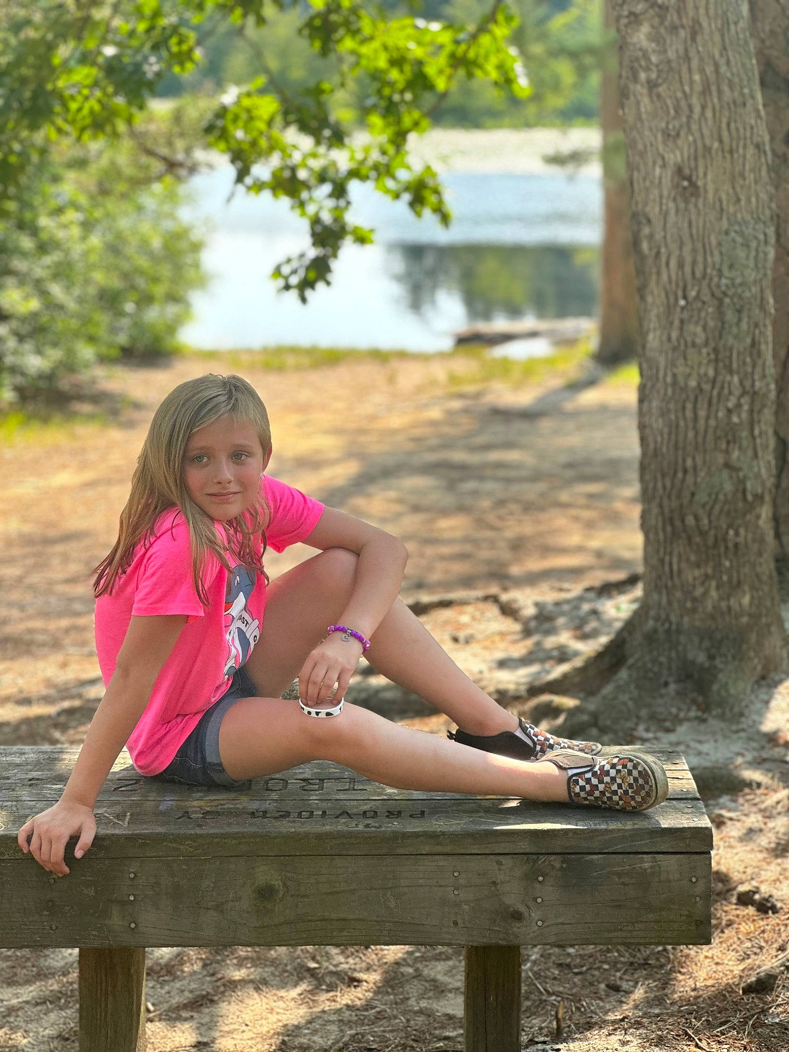 Haidyn Rose is registered to the contest to win money with this photo: eyewear, fawn, grass, hairstyle, happy, human_body, joy, knee, leg, leisure, outdoor_bench, outdoor_furniture, people_in_nature, person, plant, shoe, sneakers, sunlight, thigh, tree