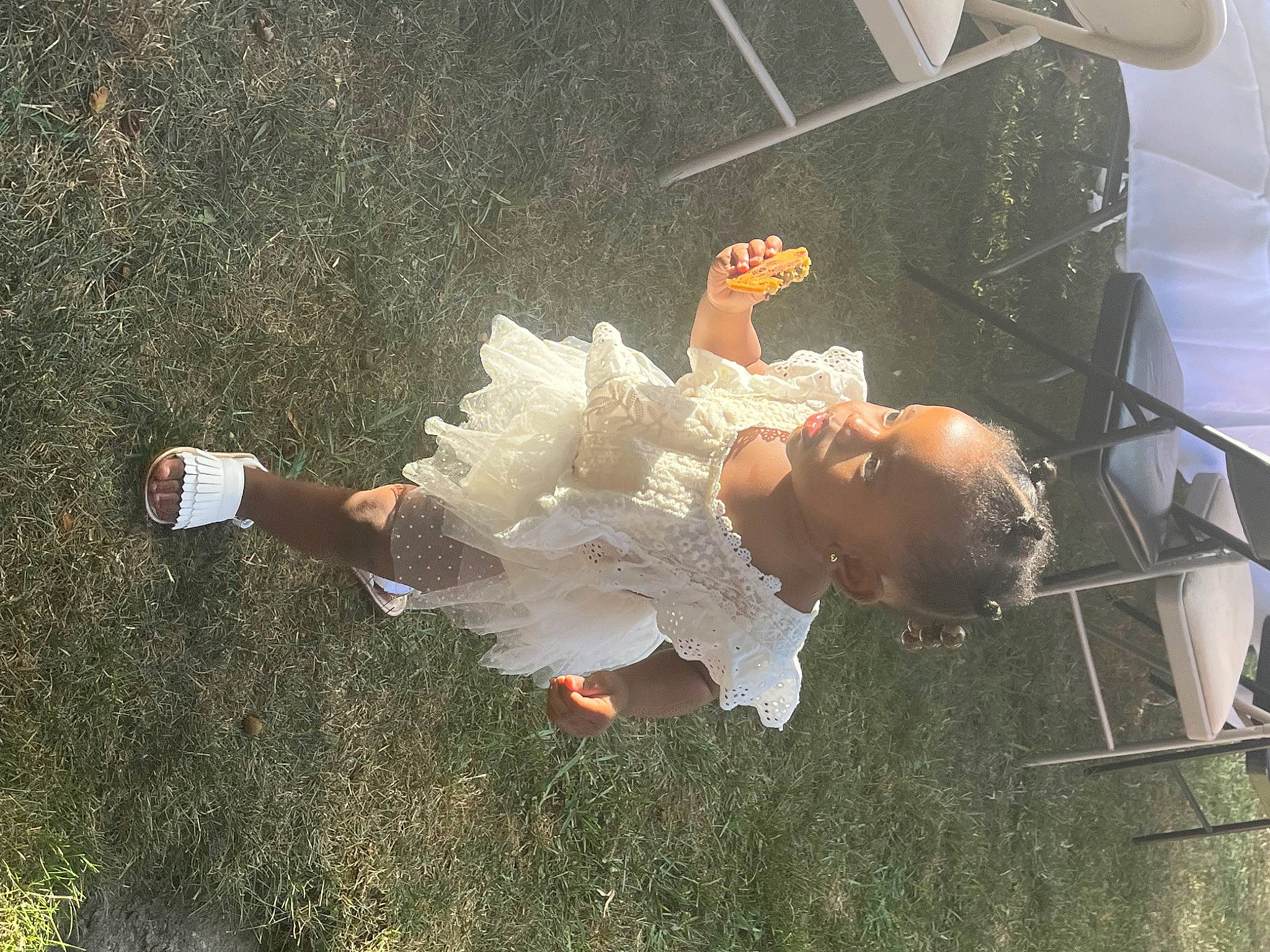 Zhuri is registered to the contest to win money with this photo: baby, dress, event, flash_photography, fun, grass, happy, leg, leisure, people_in_nature, person, space, toddler