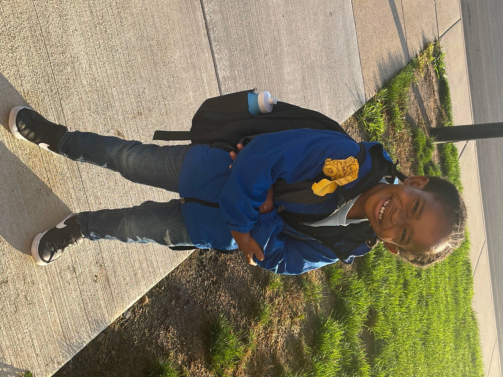 Mekhi is registered to the contest to win money with this photo: asphalt, electric_blue, fun, grass, hat, human_leg, joy, landscape, leisure, people_in_nature, person, plant, road_surface, shadow, sidewalk, sitting, soil, sunglasses, tints_and_shades, walking_shoe