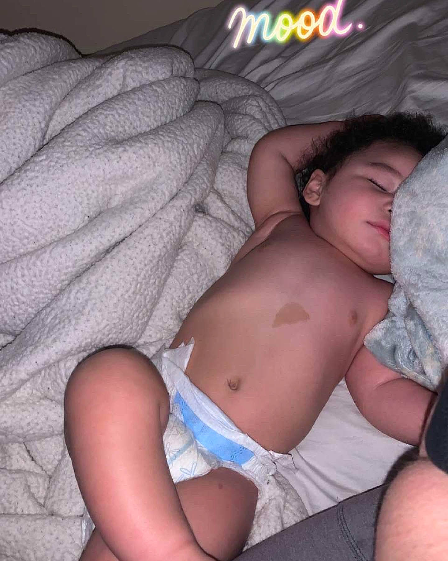 Kaymen is registered to the contest to win money with this photo: abdomen, baby, bed, chest, comfort, diaper, finger, human_leg, knee, leg, linens, mouth, muscle, person, skin, stomach, thigh, thumb, toddler, trunk