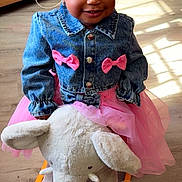 Demechala is registered to the contest to win money with this photo: toddler, child, denim_jacket, pink_bows, pink_tutu, plush_elephant, rocker, indoor, wooden_floor, sunlight, smiling, braided_hair, toy, cute, happy, girl, playful, furniture, portrait, clothing