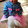 toddler, child, denim_jacket, pink_bows, pink_tutu, plush_elephant, rocker, indoor, wooden_floor, sunlight, smiling, braided_hair, toy, cute, happy, girl, playful, furniture, portrait, clothing