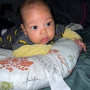 Lyam a rejoint le concours — aidez-le/la à gagner de superbes lots ! baby, infant, pillow, batman, pajamas, clothing, face, eyes, hand, bed, blanket, sleepwear, cute, indoors, person, portrait, child, young, expression, curious