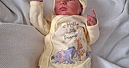 Oaklei Storm is registered to the contest to win money with this photo: baby, bed, blanket, cartoon_characters, child, clothing, cute, hat, indoor, infant, lying_down, newborn, pajamas, peaceful, person, sleepy, small_hands, soft_texture, winnie_the_pooh, yellow_outfit