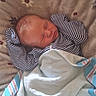 newborn, baby, sleeping, blanket, striped_clothing, soft, cozy, infant, face, head, pattern, fabric, rest, peaceful, cute, child, portrait, bed, comfort, warm