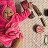 baby, beauty_products, blanket, bow, child, cosmetics, cute, face, happy, indoors, infant, lotion, perfume, person, pink_robe, portrait, powder, skin_care, smiling, texture