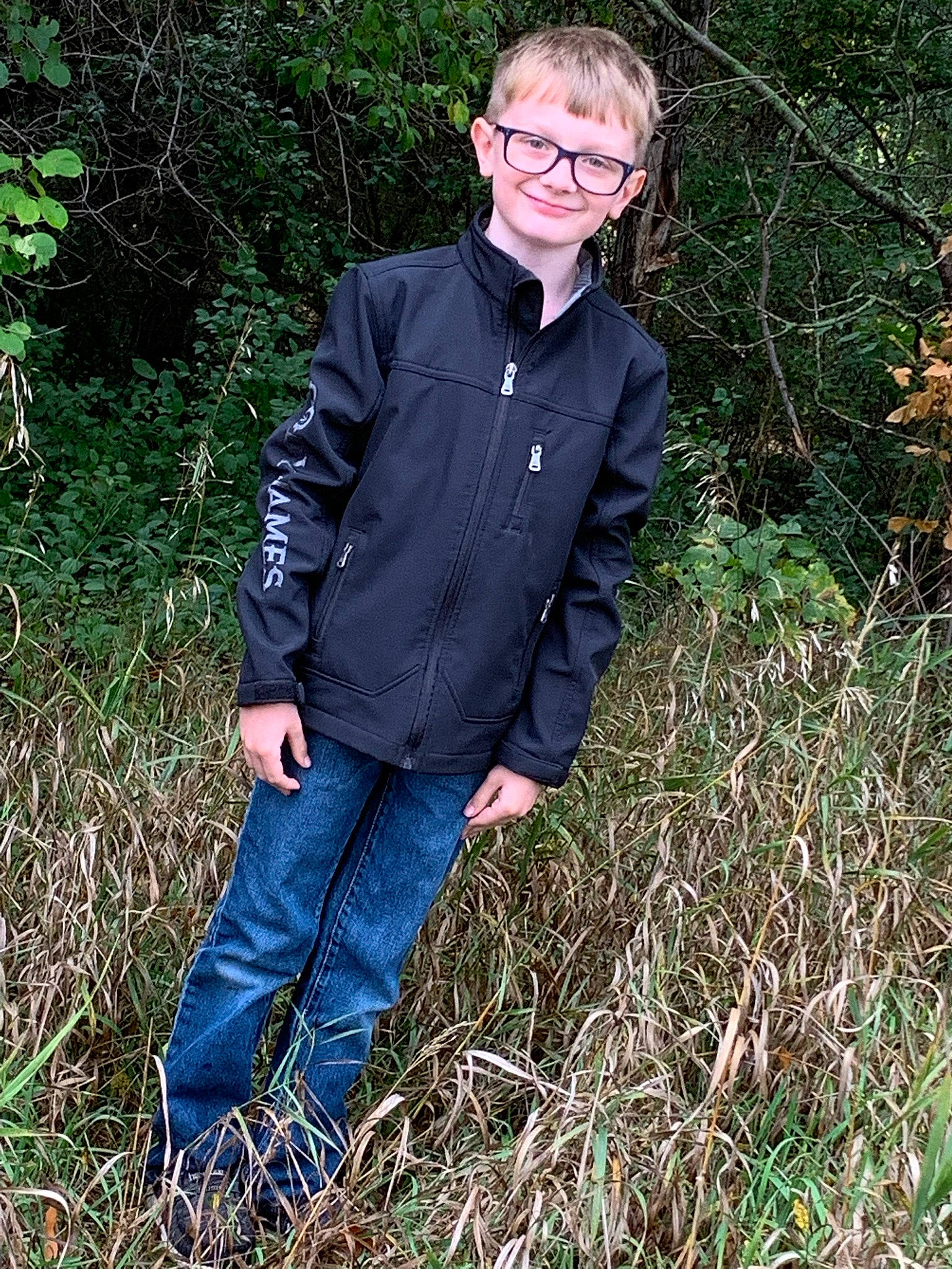 Ryland joined the competition — help win amazing prizes! blazer, button, clothing, collar, denim, dress_shirt, eyewear, formal_wear, glasses, grass, grass_family, grassland, human_body, joy, people_in_nature, person, plant, shirt, sleeve, smile