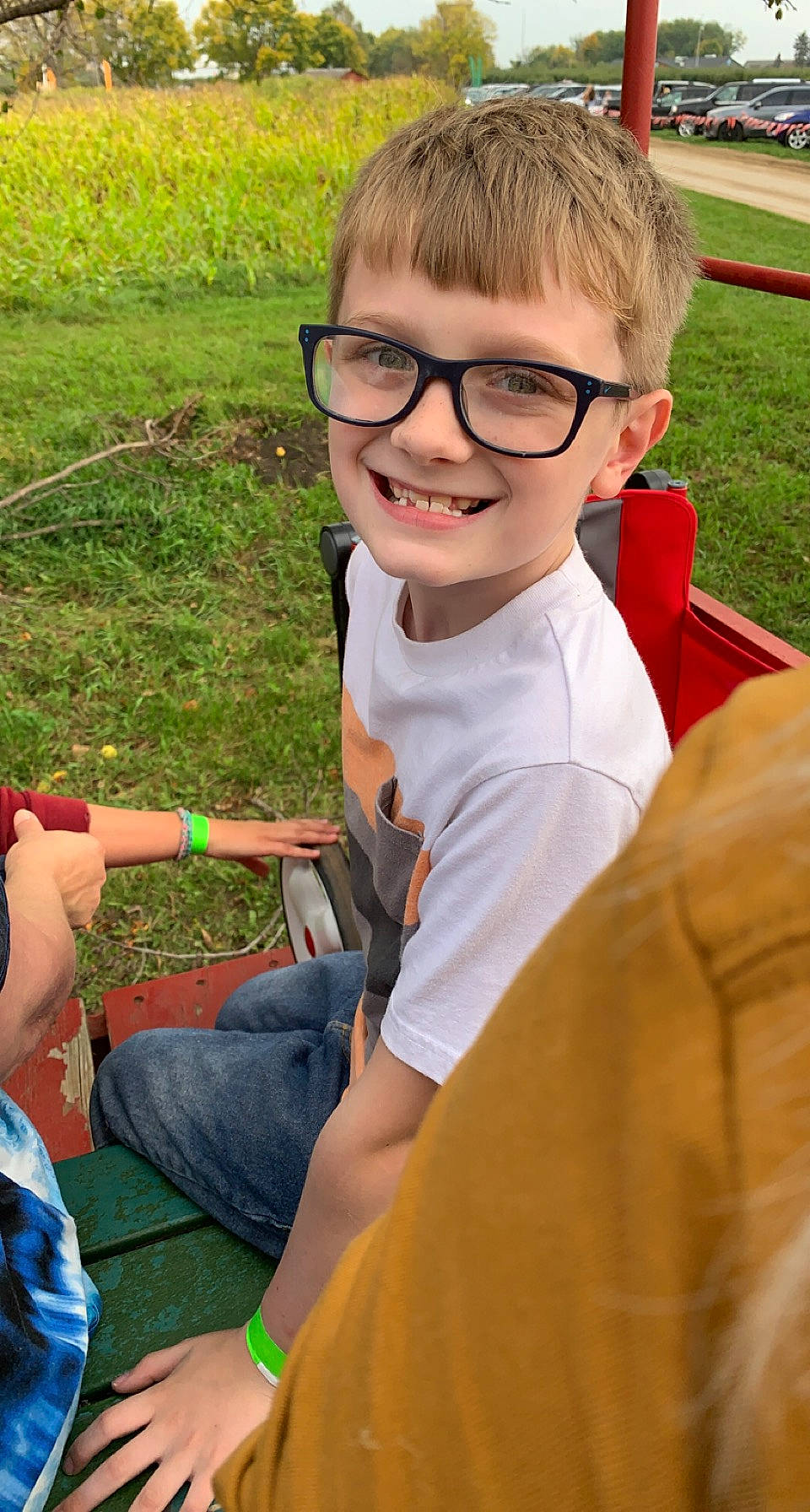 Ryland is registered to the contest to win money with this photo: arm, child, cool, eyewear, facial_expression, finger, fun, glasses, grass, hairstyle, hand, happy, joy, leisure, mammal, person, recreation, shorts, smile, social_group