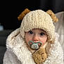 baby, child, pacifier, hat, knit_hat, ears, teddy_bear, stuffed_animal, coat, fluffy, white, portrait, face, blue_eyes, cute, warm_clothing, indoor, closeup, soft_texture, winter