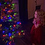 Charlee Grace is registered to the contest to win money with this photo: accessories, bracelet, child, christmas, christmasdecorations, christmastree, christmastreeornaments, conifer, face, female, festival, girl, head, jewelry, lighting, person, photography, plant, portrait, tree
