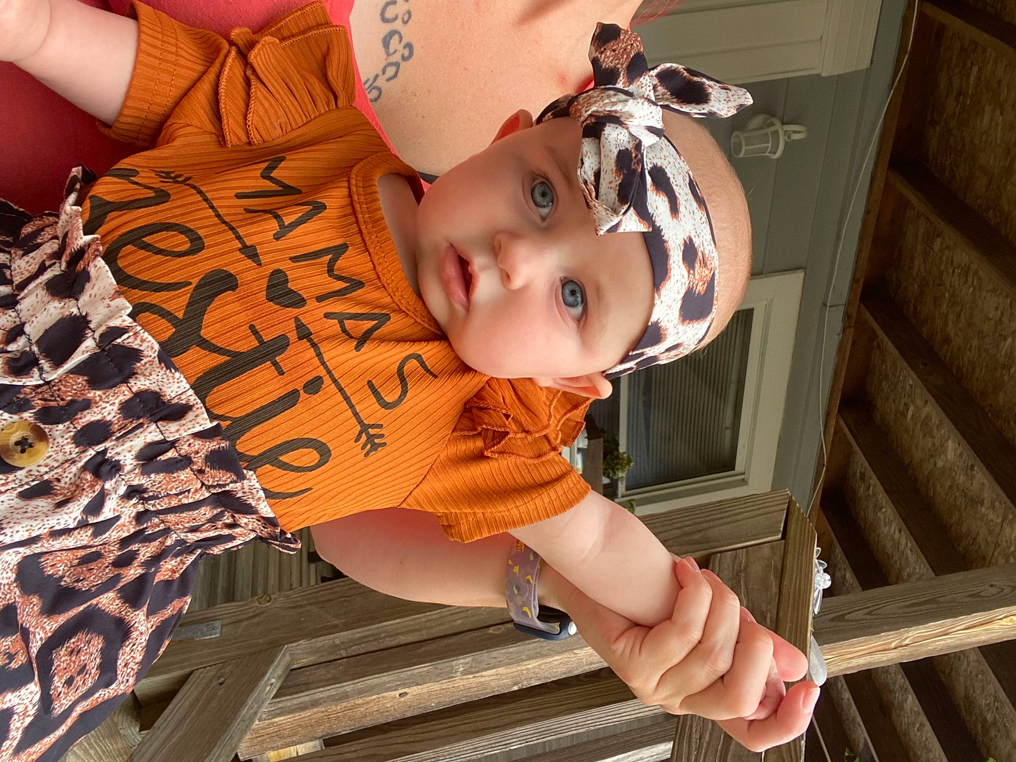 Kahlani is registered to the contest to win money with this photo: baby, baby_toddler_clothing, child, fun, happy, hat, headwear, human_body, mouth, orange, pattern, person, skin, t_shirt, toddler, tree, wood