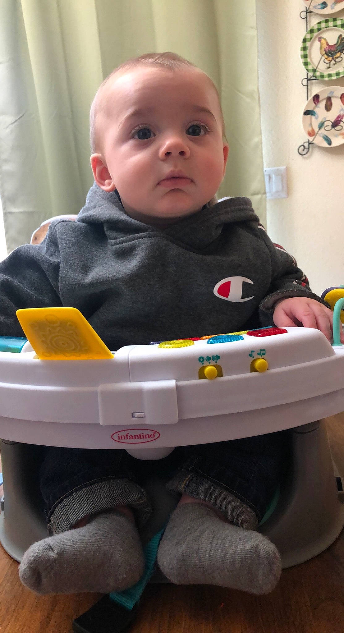 Michael is registered to the contest to win money with this photo: baby, baby_products, baby_toddler_clothing, blue, cheek, child, face, fun, green, hairstyle, head, iris, person, photograph, product, sitting, skin, toddler, toy, white