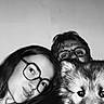 woman, man, glasses, dog, puppy, black_and_white, selfie, portrait, indoor, face, smile, candid, closeup, pet, animal, happy, casual, people, head, hair