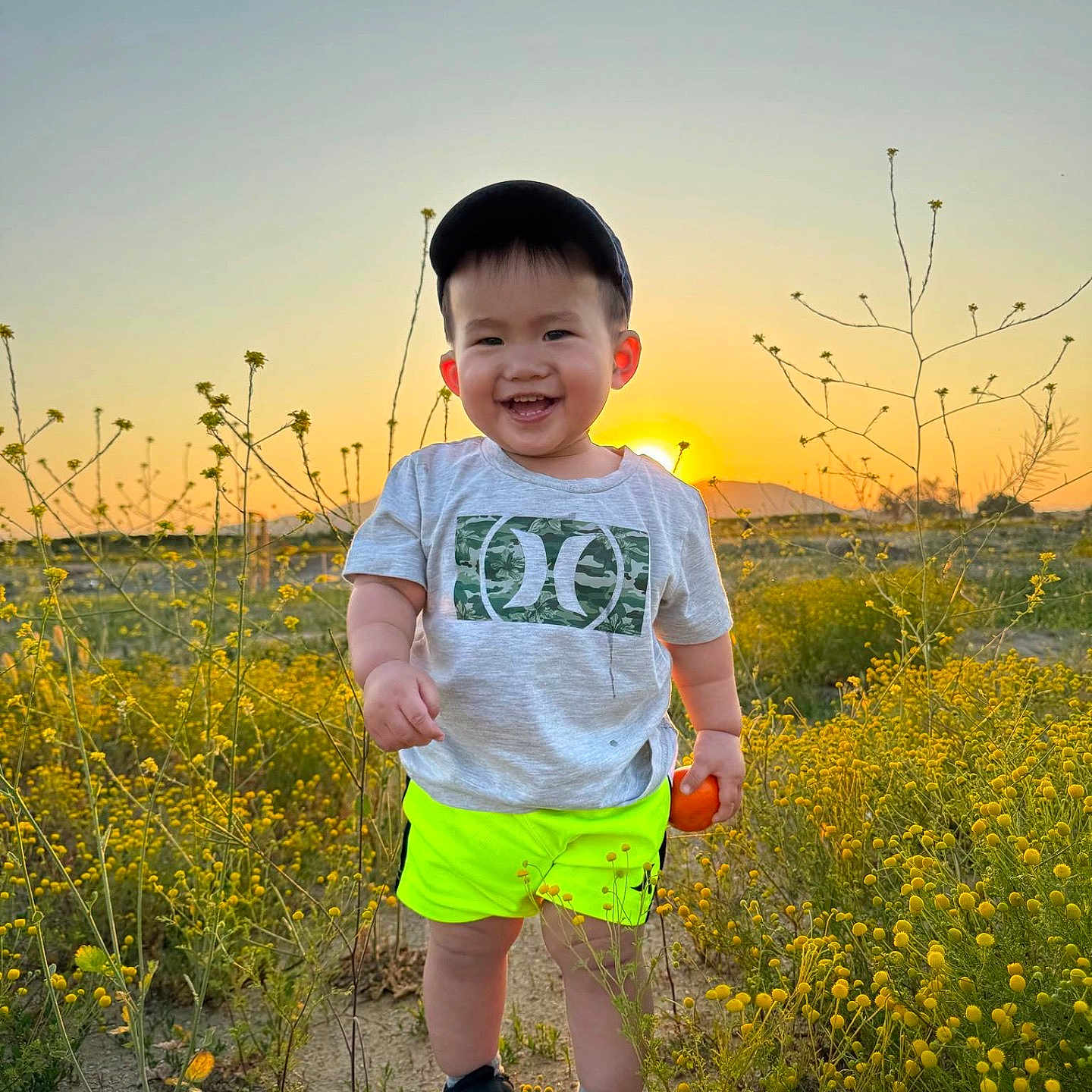 Xavier is registered to the contest to win money with this photo: boy, child, clothing, face, grass, head, herbal, herbs, male, nature, outdoors, person, photography, plant, portrait, shorts, sky, summer, t_shirt, vegetation