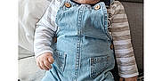 Yaël participe au concours pour gagner de l'argent avec cette photo : baby, blue_eyes, child, chubby_cheeks, clothing, couch, cute, denim_overalls, expression, face, furniture, hands, home, indoor, infant, person, portrait, sitting, soft_lighting, striped_shirt