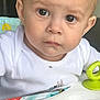 Kairo is registered to the contest to win money with this photo: baby, child, face, eyes, cheeks, drool, white_clothing, toy, colorful, indoor, closeup, infant, curious, play_area, plastic_toy, seat, head, expression, skin, person