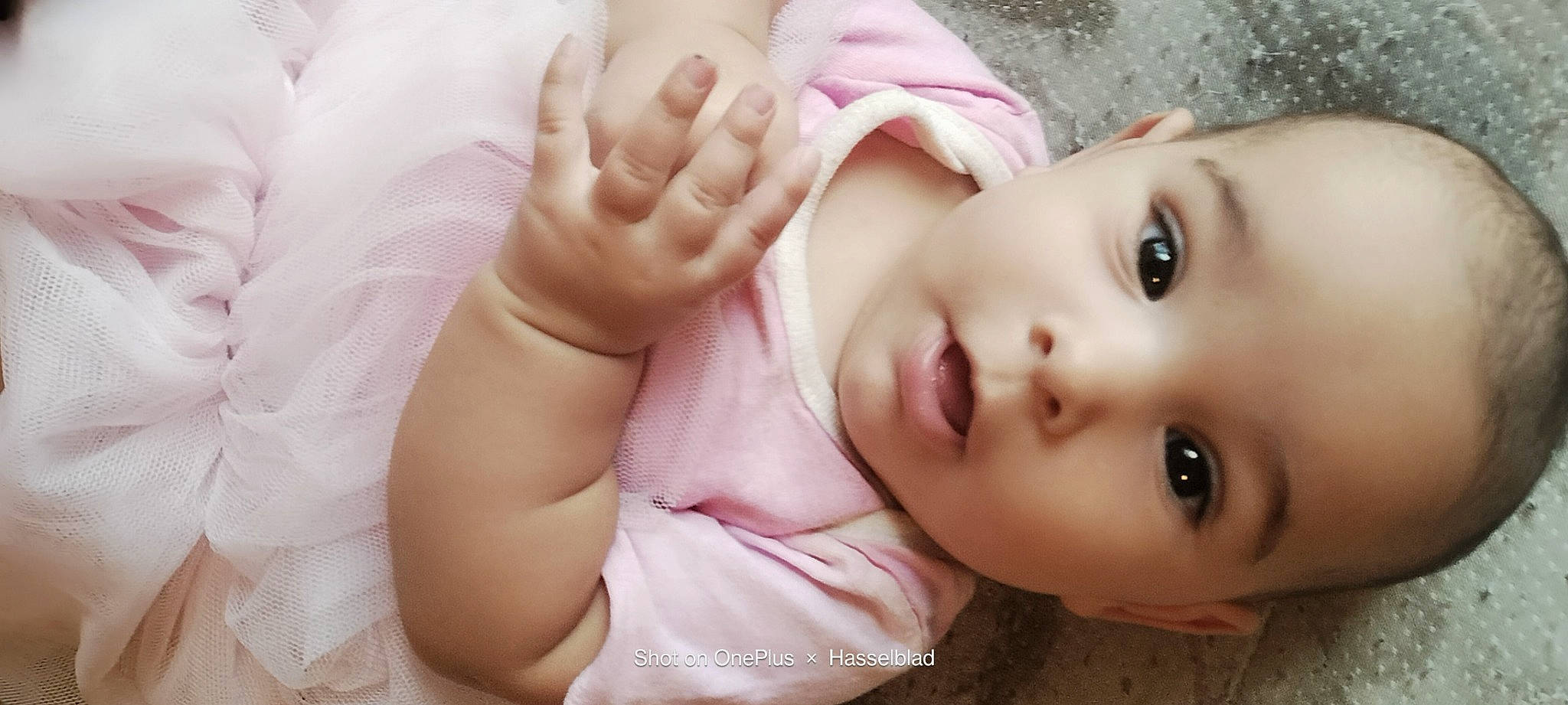 Athena is registered to the contest to win money with this photo: baby, cheek, child, comfort, eye, eyelash, face, finger, foot, gesture, happy, human_body, lip, nail, neck, no_expression, nose, person, skin, thumb
