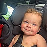baby, child, car_seat, car_interior, seatbelt, smile, face, skin, head, hair, shoulder, straps, safety, vehicle, window, sunroof, daylight, expression, cute, infant