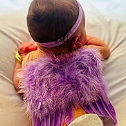 Khaleesie Lynn joined the competition — help win amazing prizes! baby, infant, purple_wings, headband, soft_cushion, feathers, back_view, sleeping, cute, newborn, angel, costume, skin, flesh, lying_down, adorable, child, soft_lighting, indoor, peaceful