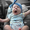 Kemberly joined the competition — help win amazing prizes! baby, infant, yawning, sleepy, headband, blue, onesie, arms_raised, sitting, portrait, close_up, face, expression, indoor, soft_focus, blurred_background, colorful_clothing, stroller, cute, child