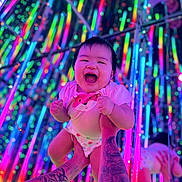 Leslie is registered to the contest to win money with this photo: baby, city, concert, face, happy, head, laughing, light, lighting, nature, night, outdoors, person, photography, portrait, purple, skin, smile, tattoo, urban