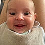 baby, bib, cheeks, closeup, clothing, cute, expression, eyes, face, happy, head, human, indoors, infant, lap, mouth, person, sitting, skin, smiling