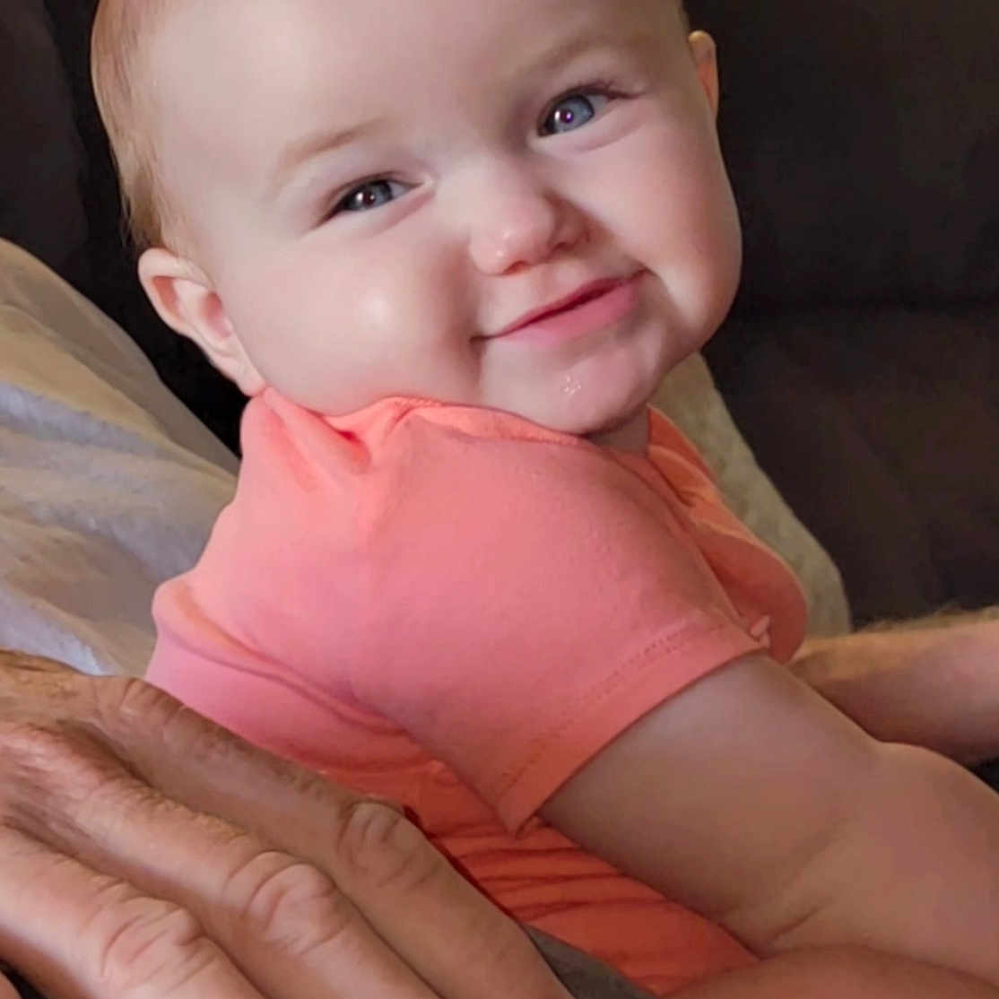 Laney Dru is registered to the contest to win money with this photo: baby, blanket, child, closeup, clothing, comfort, couch, cute, face, family, hand, happy, indoors, infant, person, portrait, seated, skin, smile, young