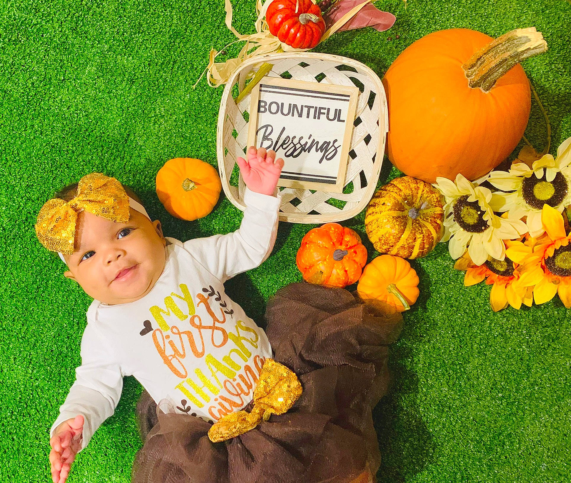 Mckinlee is registered to the contest to win money with this photo: baby_toddler_clothing, calabaza, cucurbita, food_group, gourd, grass, handwriting, happy, hat, headwear, natural_foods, orange, person, plant, produce, pumpkin, smile, squash, toddler, vegetable