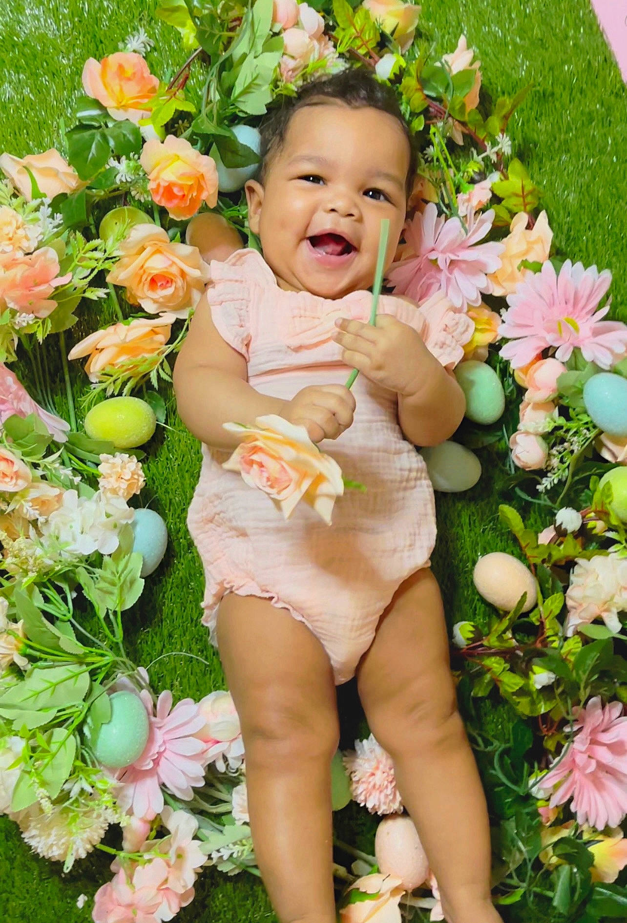 Mckinlee joined the competition — help win amazing prizes! baby_toddler_clothing, botany, facial_expression, flower, flower_arranging, flowering_plant, grass, green, happy, meadow, nature, people_in_nature, person, petal, photograph, pink, plant, skin, smile, summer