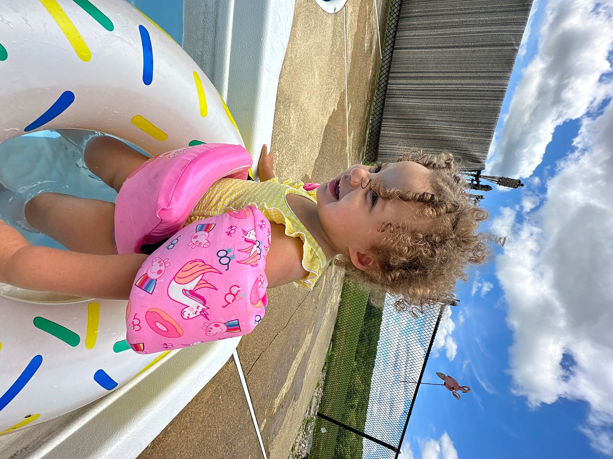 Luna-rose is registered to the contest to win money with this photo: child, cloud, eyewear, fun, green, happy, leisure, magenta, pattern, person, photography, recreation, sky, snapshot, thigh, toddler, tree, vacation, water, white