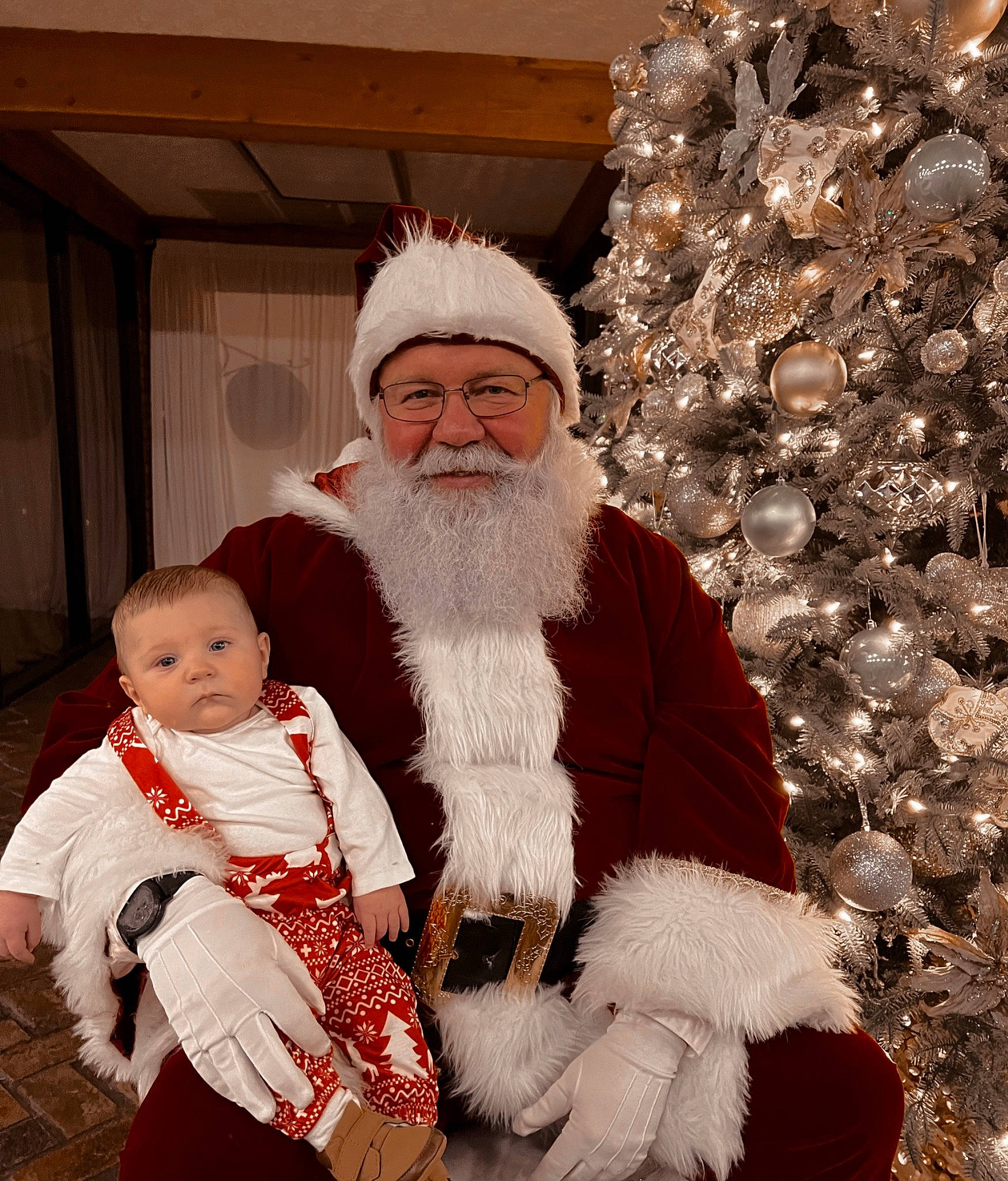 Colton joined the competition — help win amazing prizes! beard, christmas, christmas_decoration, christmas_eve, christmas_tree, comfort, event, facial_hair, fur, fur_clothing, happy, hat, headwear, holiday, human_body, lap, person, santa_claus, sitting, toddler