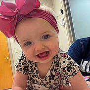 Ashlyn joined the competition — help win amazing prizes! baby, child, headband, pink_bow, hello_kitty, patterned_clothing, smiling, blue_eyes, indoor, hand, person, cute, happy, toddler, short_sleeves, infant, closeup, portrait, skin, human