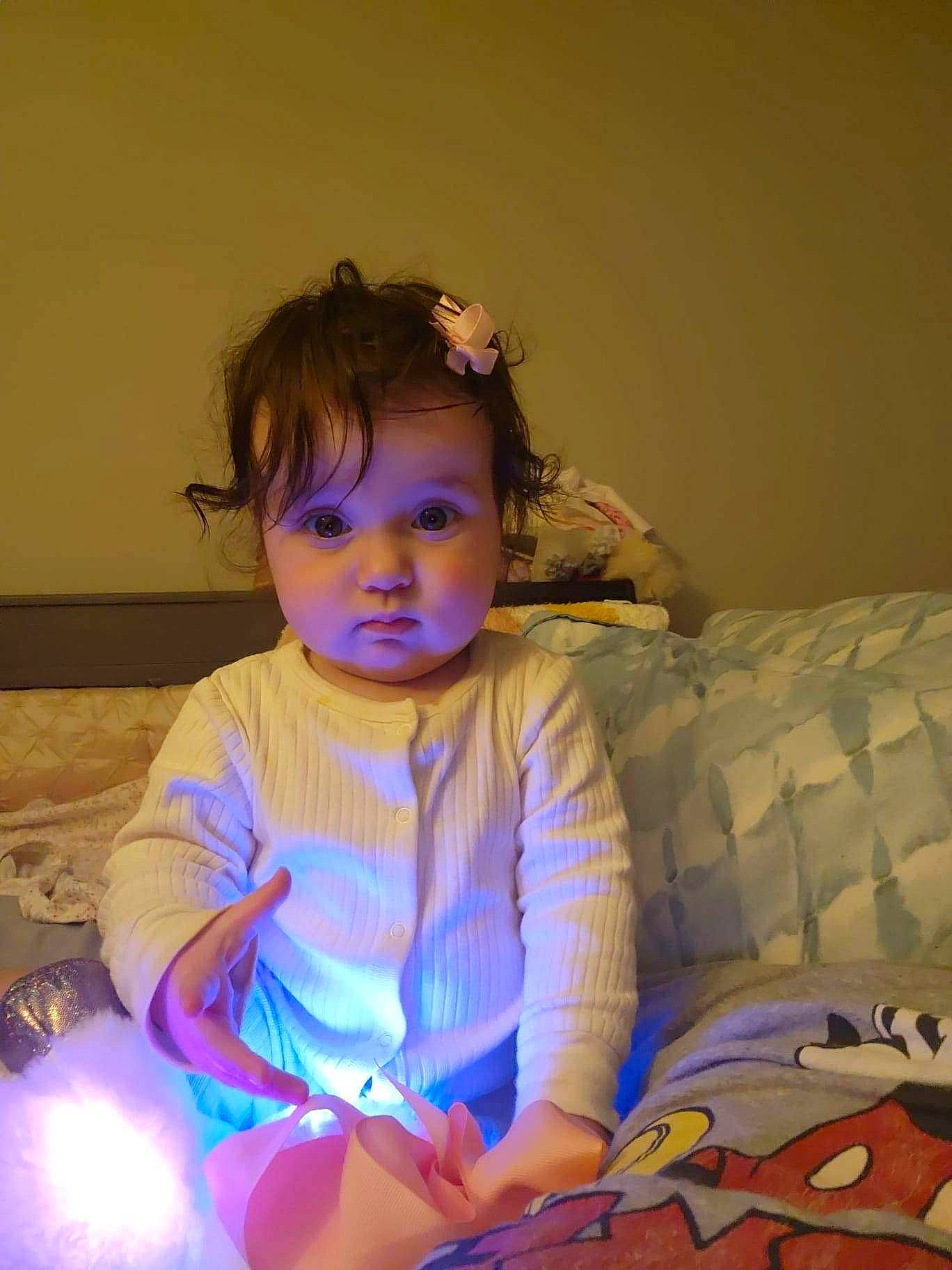 Lexie is registered to the contest to win money with this photo: baby, baby_toddler_clothing, child, electric_blue, event, eye, flash_photography, flooring, fun, happy, human_leg, iris, magenta, pattern, person, play, purple, room, sitting, t_shirt