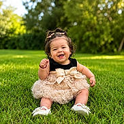 Nashly joined the competition — help win amazing prizes! baby, bow, child, curly_hair, cute, dress, fashion, grass, greenery, hair_bow, happy, nature, outdoor, park, portrait, sitting, smiling, sunlight, toddler, white_shoes