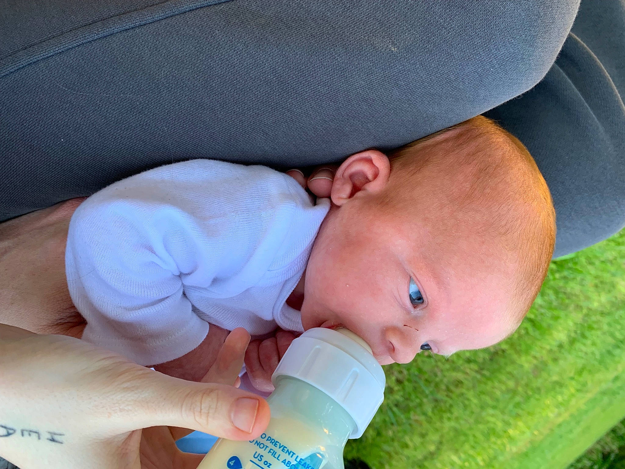 Scarlett joined the competition — help win amazing prizes! baby, baby_bottle, baby_grabbing_for_something, baby_playing_with_toys, baby_products, baby_safety, baby_toddler_clothing, cheek, child, comfort, drinkware, finger, grass, happy, nail, person, plastic_bottle, sitting, skin, thumb