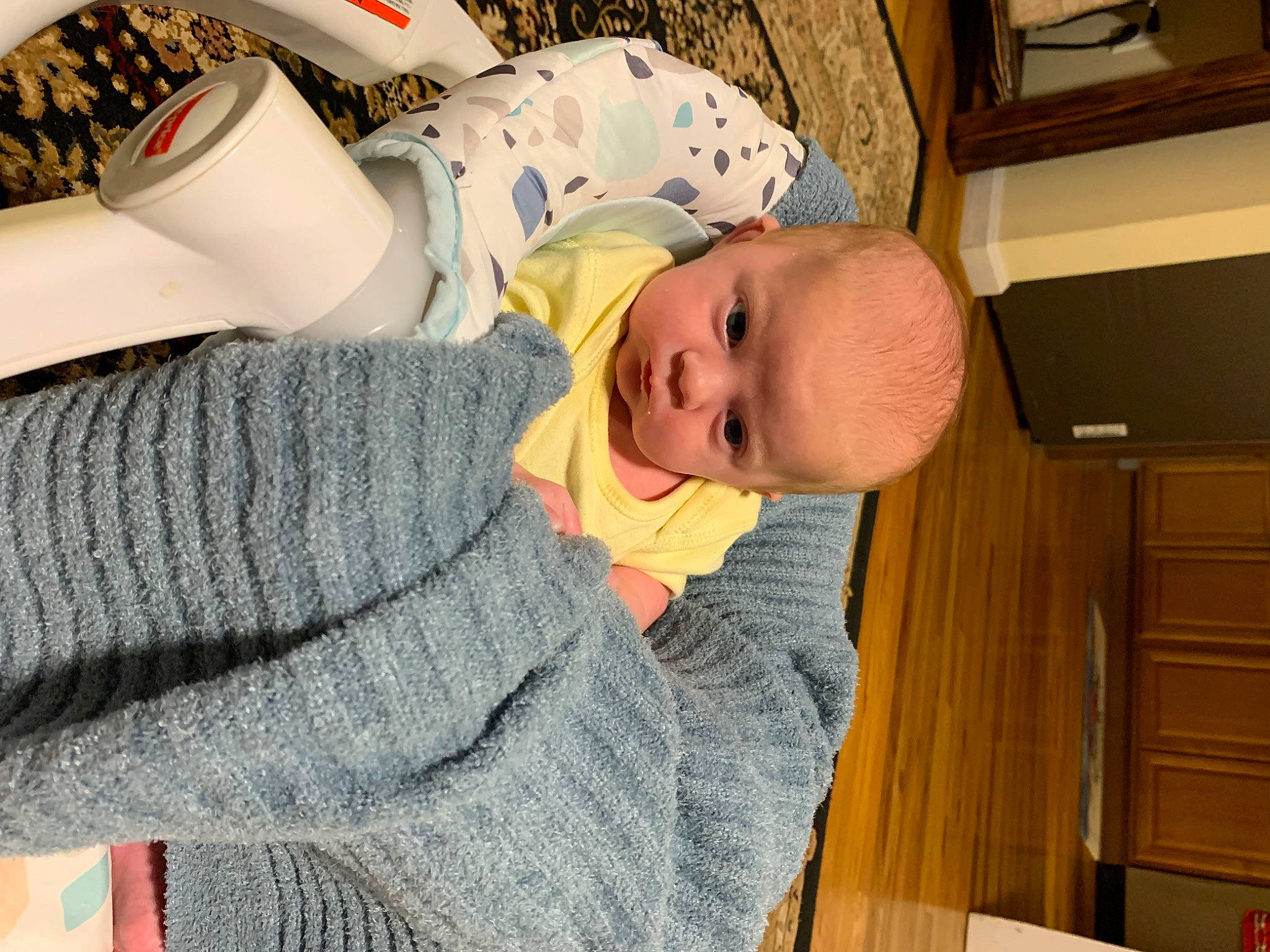 Scarlett is registered to the contest to win money with this photo: baby, baby_products, baby_safety, baby_toddler_clothing, cabinetry, child, comfort, hat, headgear, human_leg, lap, leg, linens, person, room, sitting, sleeve, smile, thigh, toddler