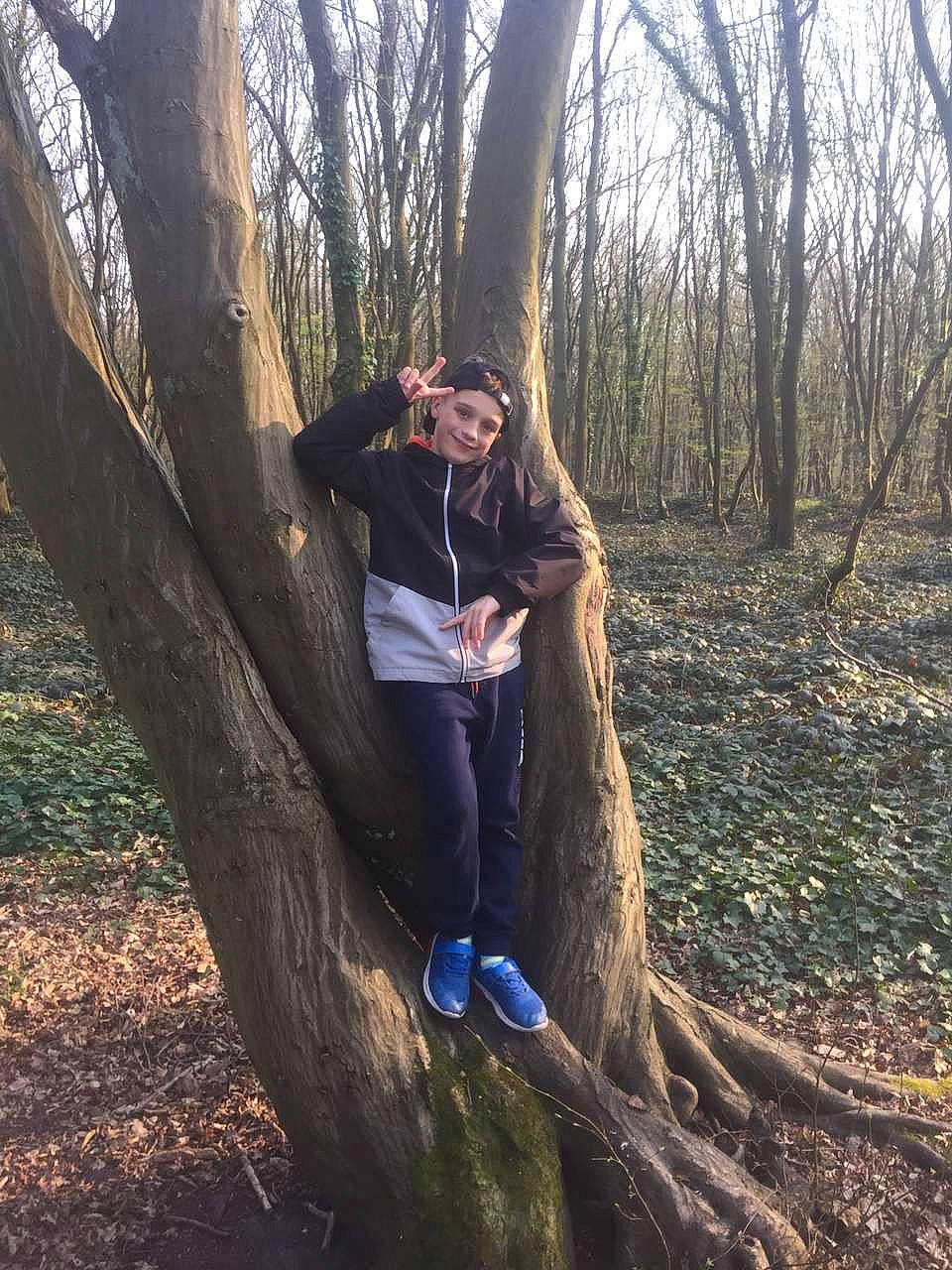 Steeven a rejoint le concours — aidez-le/la à gagner de superbes lots ! deciduous, flash_photography, forest, grass, grove, happy, headwear, joy, landscape, leg, long_hair, natural_landscape, people_in_nature, person, plant, sitting, soil, tints_and_shades, tree, trunk