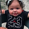 baby, child, face, headband, bow, smile, sitting, swing, outdoor, grass, shirt, number, cute, happy, portrait, person, infant, playful, skin, hair