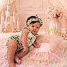 baby, infant, leopard_print, headband, pink, pillow, crown, castle, flowers, roses, fluffy_rug, decor, portrait, cute, child, indoors, soft_lighting, fairy_tale, pose, adorable