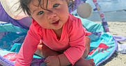Rayleigh joined the competition — help win amazing prizes! baby, child, pink_clothing, hat, beach, sand, ocean, sunny, outdoor, playmat, crawling, smiling, cute, face, infant, sunhat, colorful, toy, happy, closeup