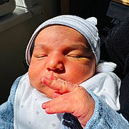 Muhammad Ali is registered to the contest to win money with this photo: newborn, baby, infant, sleeping, hat, bib, hand, face, closed_eyes, skin, cozy, indoor, sunlight, cute, tiny_fingers, clothing, portrait, peaceful, soft_light, newborn_baby