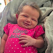 Rosalie joined the competition — help win amazing prizes! newborn, baby, infant, child, portrait, smiling, lying_down, pink, polka_dots, onesie, blanket, cozy, bed, face, hands, indoor, close_up, happy, cute, text_on_clothing