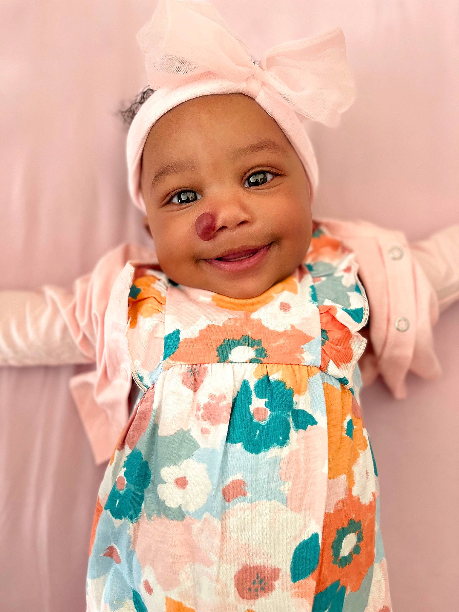 Keira is registered to the contest to win money with this photo: baby, baby_toddler_clothing, beauty, child, dress, event, face, happy, headgear, joy, outerwear, pattern, peach, person, pink, product, skin, sleeve, smile, textile