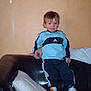 Leo participe au concours pour gagner de l'argent avec cette photo : toddler, child, adidas, tracksuit, sneakers, couch, leather, pillow, indoor, hand, person, wall, standing, clothing, footwear, young_child, home, balance, support, casual