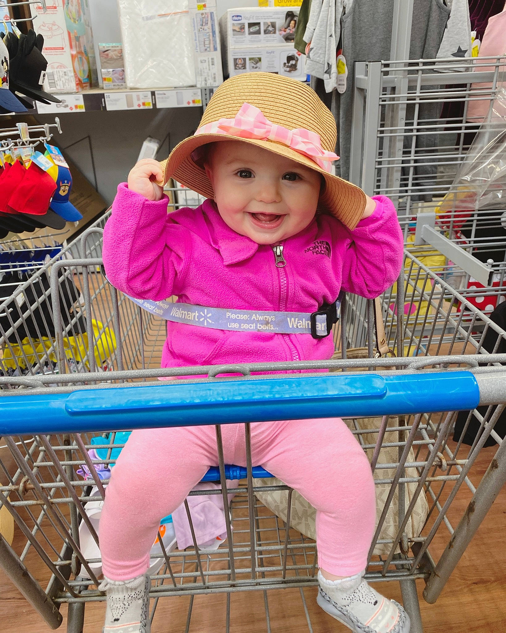 Bexleigh is registered to the contest to win money with this photo: child, customer, footwear, fun, happy, headwear, joy, leisure, magenta, person, photograph, pink, public_space, shoe, shopping, shopping_cart, smile, standing, tire, toddler