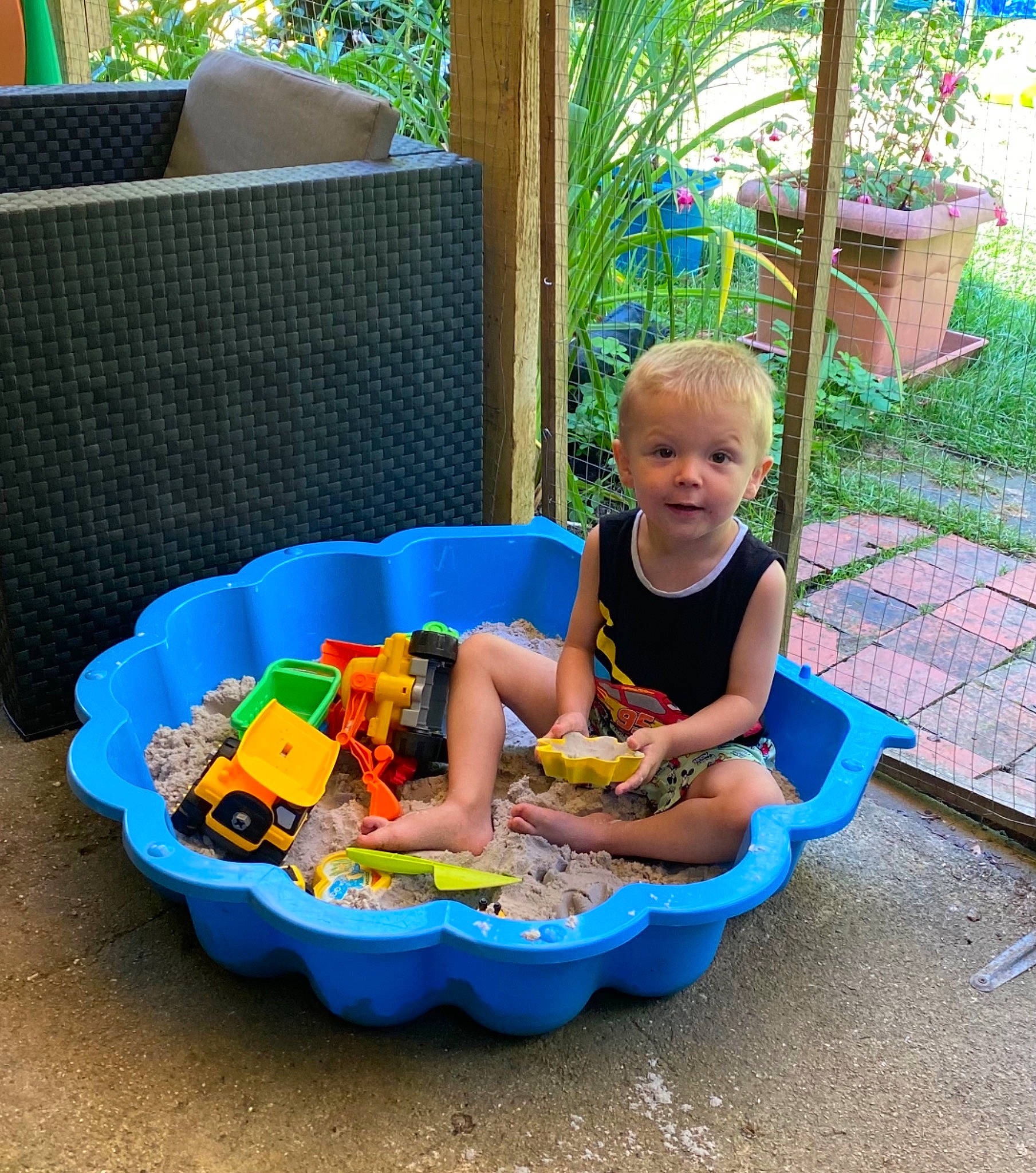 élio participe au concours pour gagner de l'argent avec cette photo : baby_playing_with_toys, baby_products, baby_toddler_clothing, baby_toys, chair, child, fun, leisure, outdoor_furniture, person, plant, plastic, play, recreation, sharing, shorts, sitting, toddler, toy, toy_vehicle