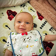 Brody joined the competition — help win amazing prizes! baby, smiling, bib, farm_animals, blanket, barn, cow, duck, sheep, tractor, toddler, cute, infant, lying_down, happy, clothing, pattern, face, child, soft