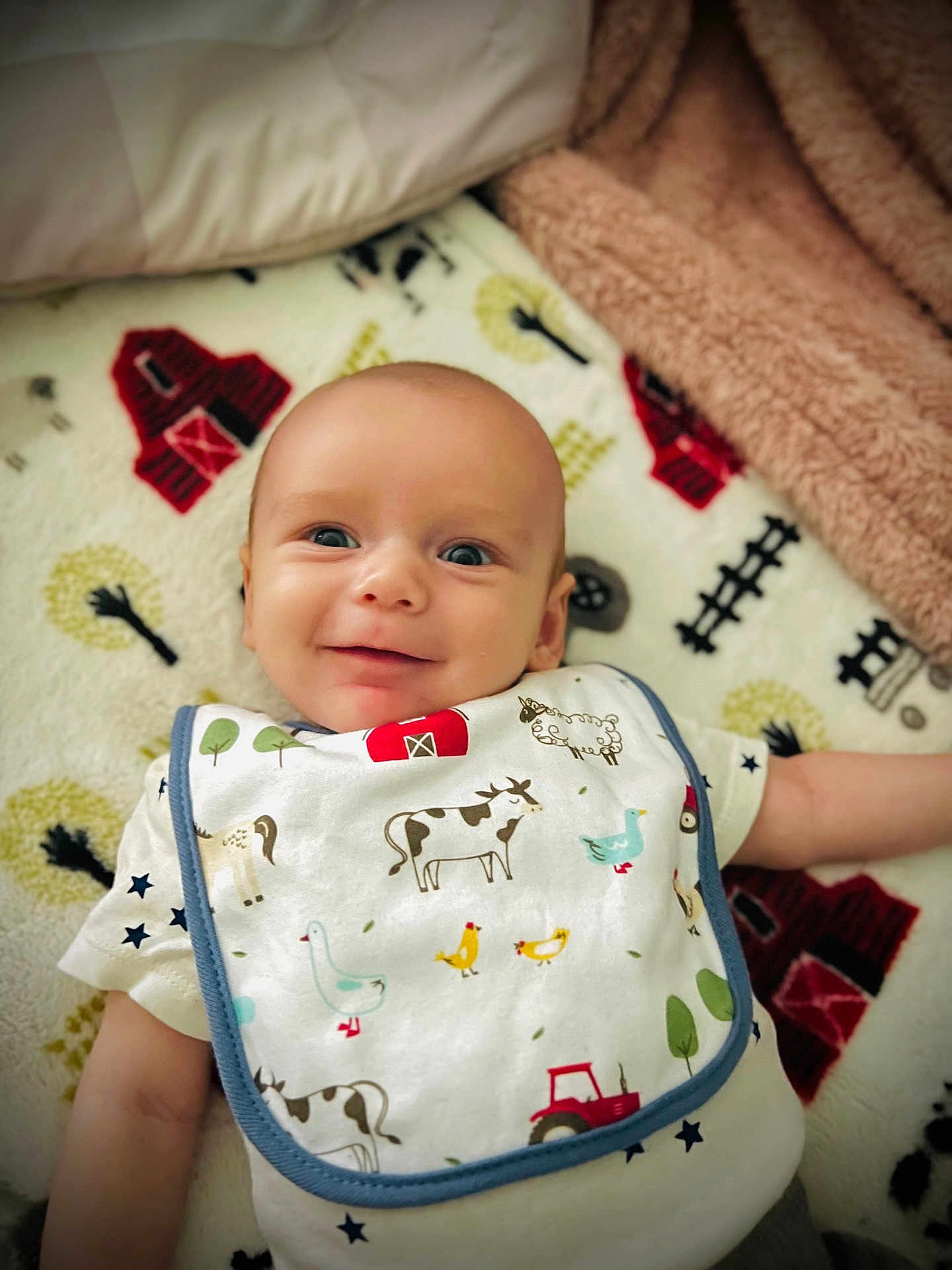 Brody joined the competition — help win amazing prizes! baby, smiling, bib, farm_animals, blanket, barn, cow, duck, sheep, tractor, toddler, cute, infant, lying_down, happy, clothing, pattern, face, child, soft