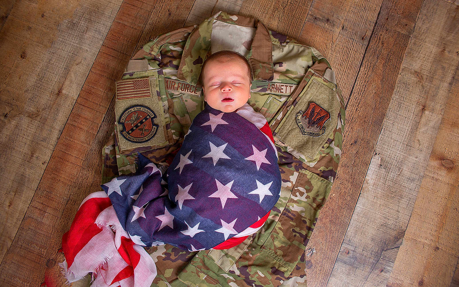 Cade joined the competition — help win amazing prizes! newborn, baby, flag, american_flag, camouflage, military_uniform, wooden_floor, sleeping, wrapped, infant, peaceful, portrait, person, flooring, fabric, indoor, closeup, resting, soft, symbolic