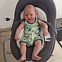 baby, infant, smiling, baby_rocker, romper, jungle_print, indoor, floor, power_outlet, modern_furniture, child, cute, happy, seated, legs, arms, head, face, skin, home